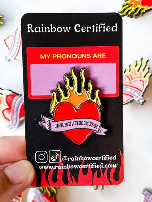 
            
                Load image into Gallery viewer, RAINBOW CERTIFIED FLAMING HEART HE/HIM ENAMEL PIN
            
        